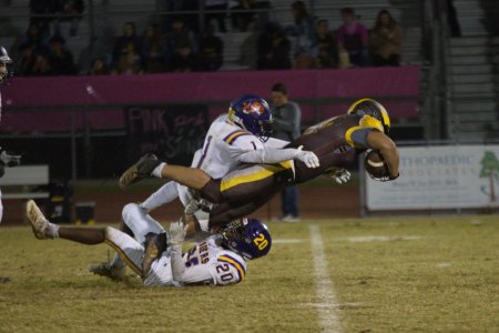 Aaron Villerreal and Ozzy Hernandez team up for a tackle during Friday night's win at Golden West, helping lead the Tigers to a 36-29 win.